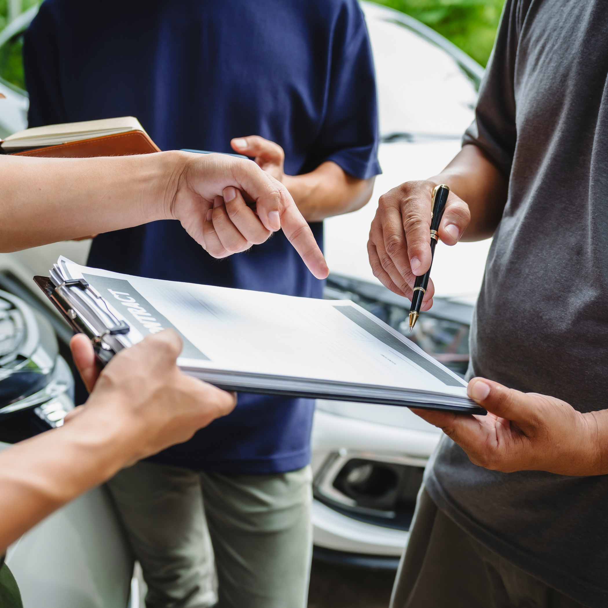 Three Asian Men Discussing Car Insurance Policies With Adjuster.